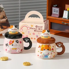 Kattmugg i keramik med lekfullt kattmotiv – vissa varianter med lock och sked