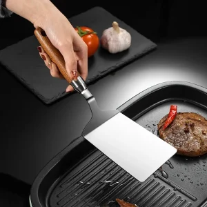 Stekspatel i rostfritt stål med trähandtag för kök och grill