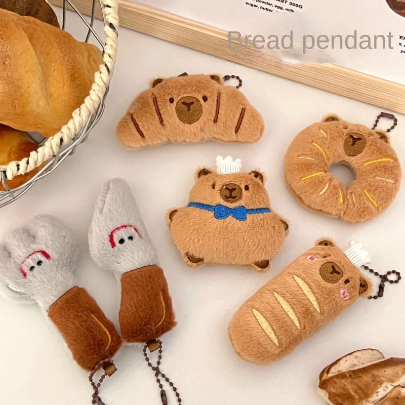 Kapybara- och delfinhängen i tecknad stil med bröd- och matmotiv samt kreativ design 36 Visa flera brödformade capybara-hängen i olika former och färger.