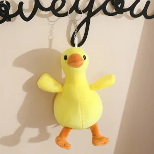 Söt vit gås och gul anka som mjuk plyschfigur, väskhänge och födelsedagspresent