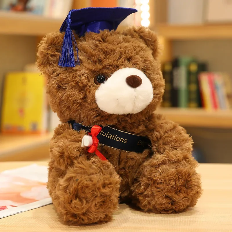 Björn gosedjur som björnkudde, Graduation björn och Wearing a doctor cap, 23–28 cm 20 Brun nallebjörn med blå examensmössa och rött examensband.