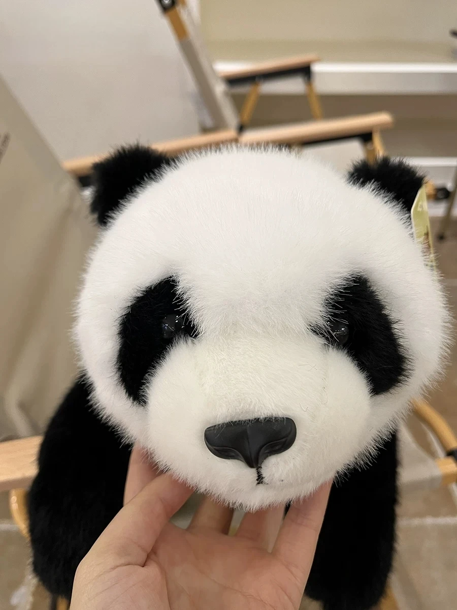 Realistiskt och sött panda gosedjur på 30 cm, viktat och mjukt för kramar och sällskap 21 Närbild på panda-gosedjurets svartvita ansikte med tydliga ögon och liten svart nos.