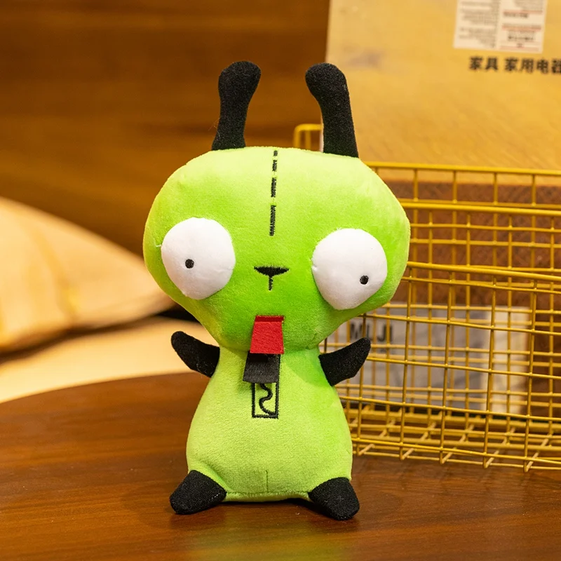 Hund gosedjur, Green och Alien invader, grön kawaii inspirerad alienfigur 19 Grön alienliknande plushfigur sedd framifrån i en inomhusmiljö.