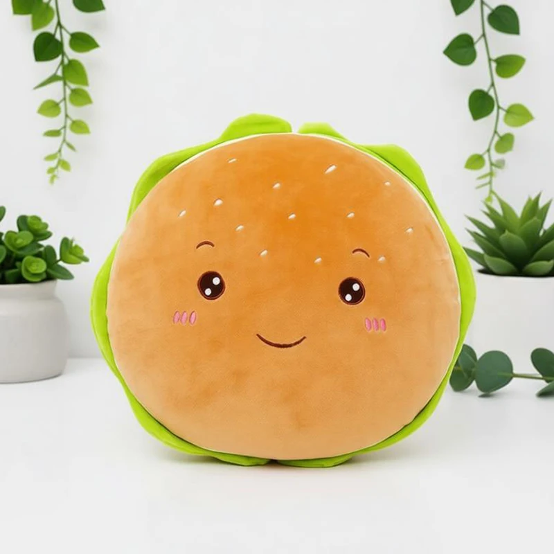 Hamburgerformat gosedjur i flera figurvarianter, fluffig plyschkudde, 40 cm 21 Hamburgerformad plysch med grönt salladsblad och ett vänligt ansikte, fotograferad framför växter.