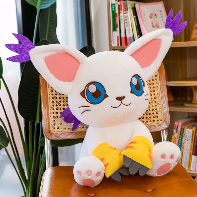 Digital Monster Tailmon gosedjur, kattkudde och kramkudde i kawaii anime-stil, 40 cm 16 Vit, blåögd kattliknande plyschfigur med rosa öron och gula fötter i en rumsmiljö.